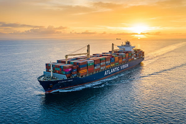 Modern container ship sailing towards the horizon symbolizing AB Export's global vision and reach.
