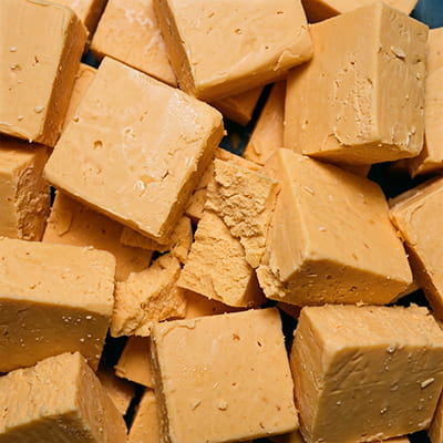 Bulk processed cheese blocks for food service and retail.